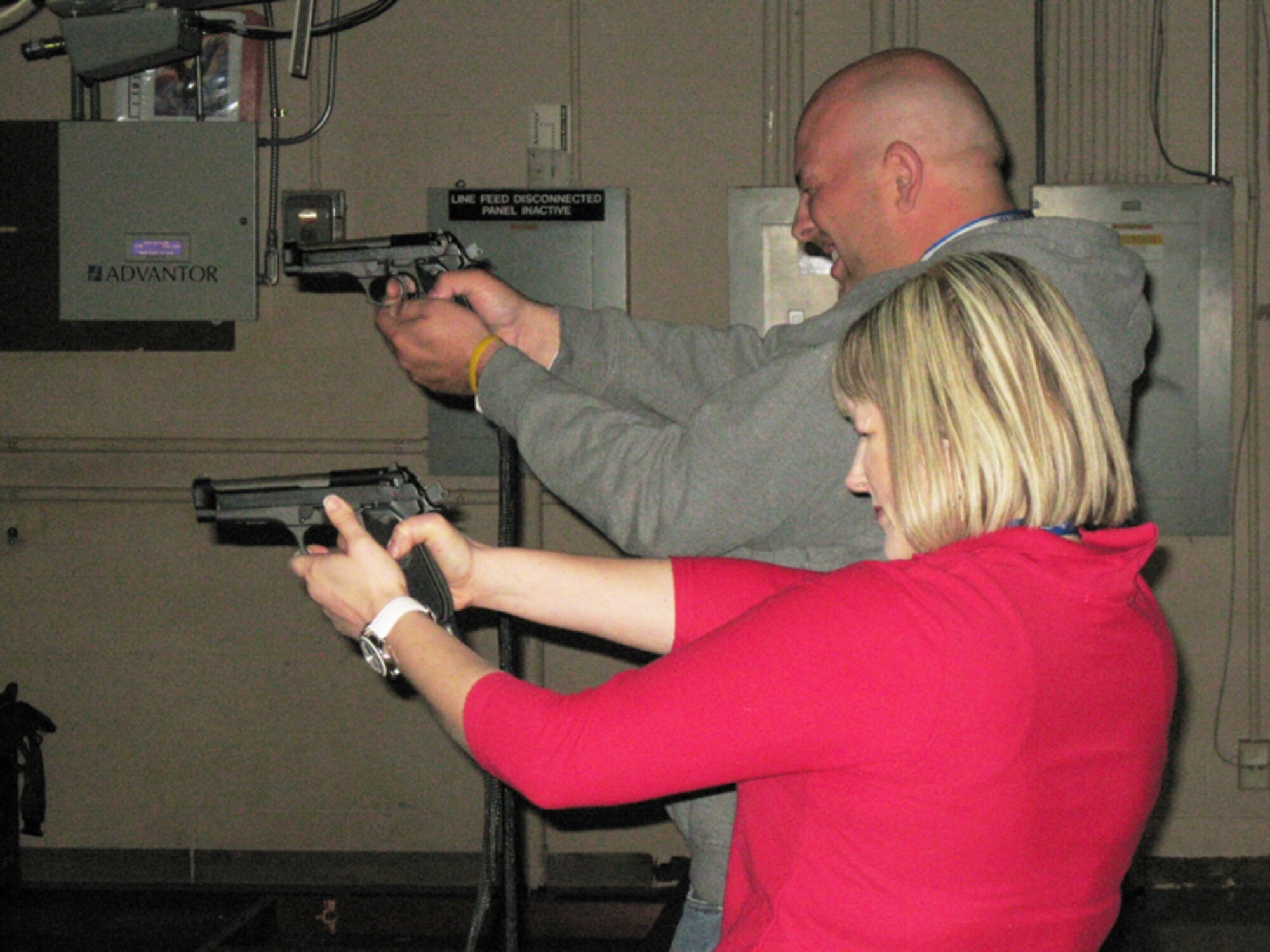 GRISSOM AIR RESERVE BASE, Ind., -- Chris Theisen, honorary 434th Air Refueling Wing Command chief, and Andrea Zwiebel, honorary 434th Mission Support Group commander, test their skill on the combat arms training simulator during a recent base visit.  Six honorary commanders toured various mission support group agencies during the visit. (U.S. Air Force photo/Lt. Col Gary Lockard)                              