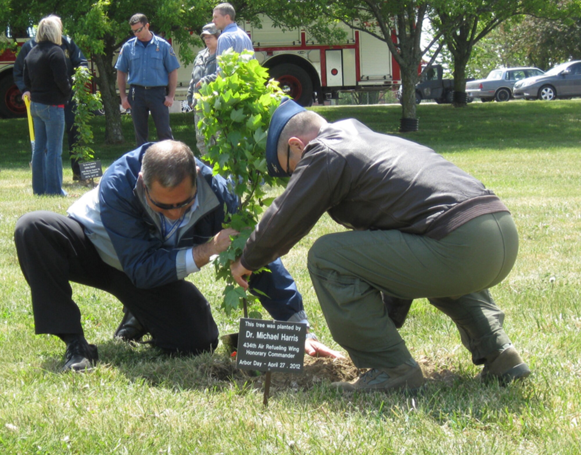 GRISSOM AIR RESERVE BASE, Ind., -- Col. William "Tim" Cahoon, 434th Air Refueling Wing commander, assists Dr. Michael Harris, honorary 434th ARW commander, during the recent Arbor Day tree planting ceremony at Grissom.   Dr. Harris, along with five other honorary commanders, participated in the ceremony which recognized Grissom's commitment to the environment and its designation as a "Tree City USA" by the National Arbor Day Foundation (U.S. Air Force photo/Lt. Col. Gary Lockard)                                                                                          