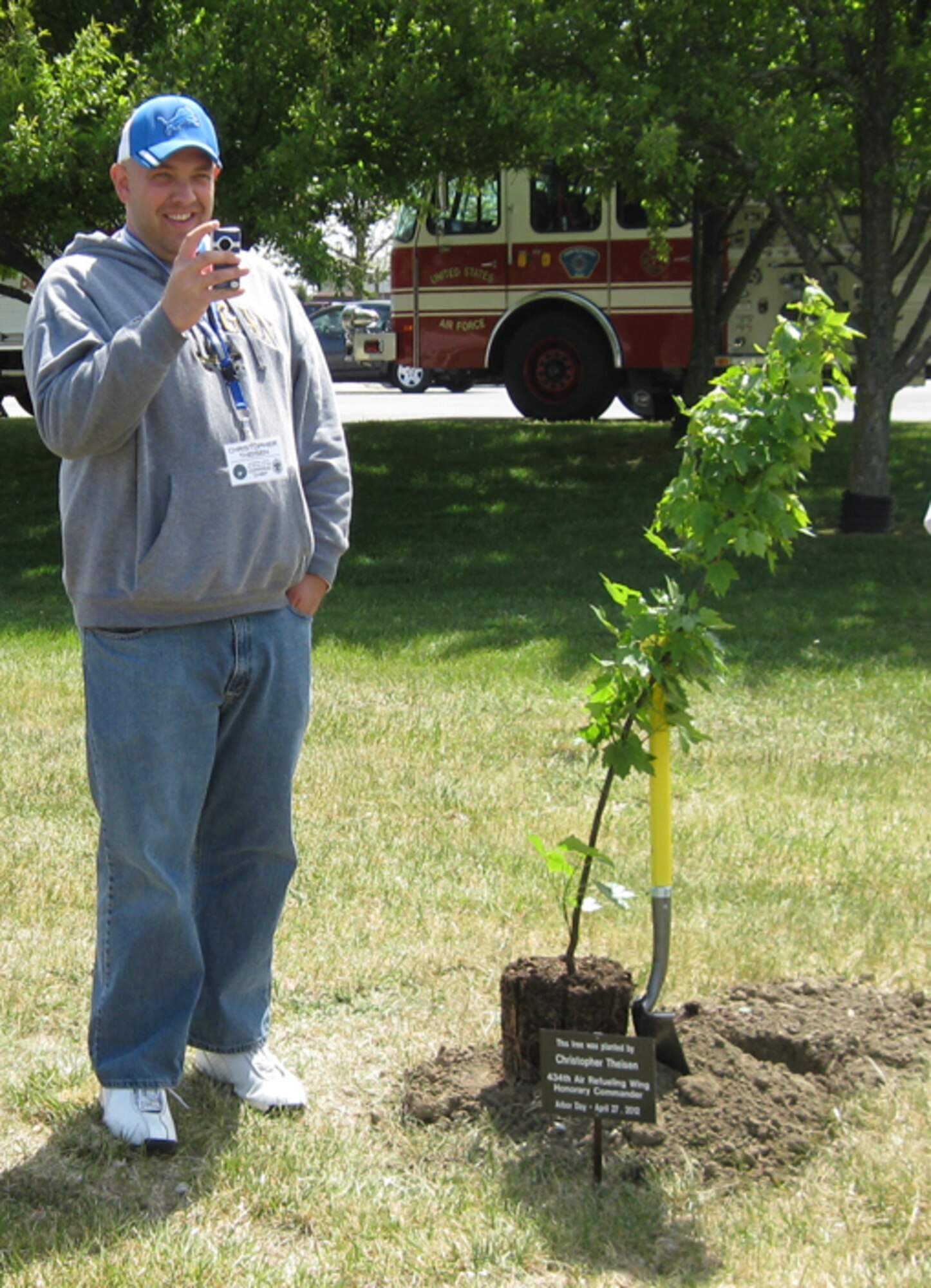GRISSOM AIR RESERVE BASE, Ind., -- Chris Theisen, honorary 434th Air Refueling Wing command chief, takes a photo during the recent Arbor Day ceremony at Grissom. Mr. Theisen, along with five other honorary commanders, participated in the ceremony which recognized Grissom's commitment to the environment and its designation as a "Tree City USA" by the National Arbor Day Foundation (U.S. Air Force photo/Lt. Col. Gary Lockard)                                                                                                                                                      