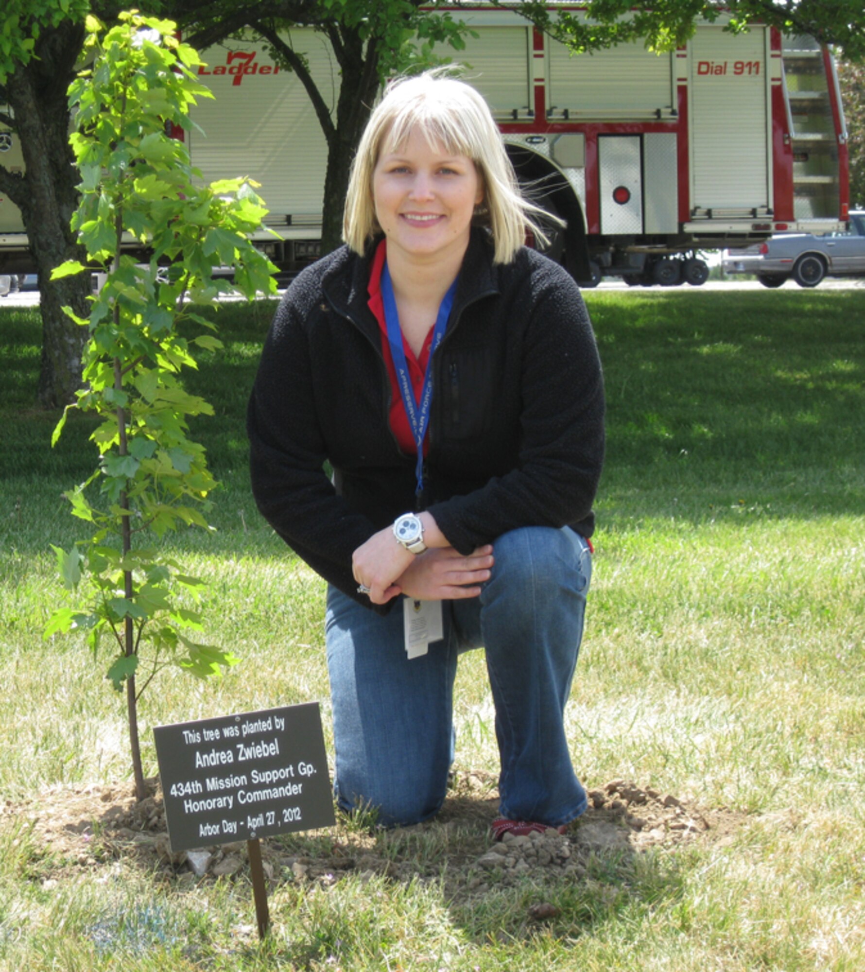 GRISSOM AIR RESERVE BASE, Ind., -- Andrea Zwiebel, honorary 434th Mission Support Group commander, poses alongside the tree she planted during the recent Arbor Day ceremony at Grissom. Ms Zwiebel, along with five other honorary commanders, participated in the ceremony which recognized Grissom's commitment to the environment and its designation as a "Tree City USA" by the National Arbor Day Foundation (U.S. Air Force photo/Lt. Col. Gary Lockard)                                                                                                                                                      