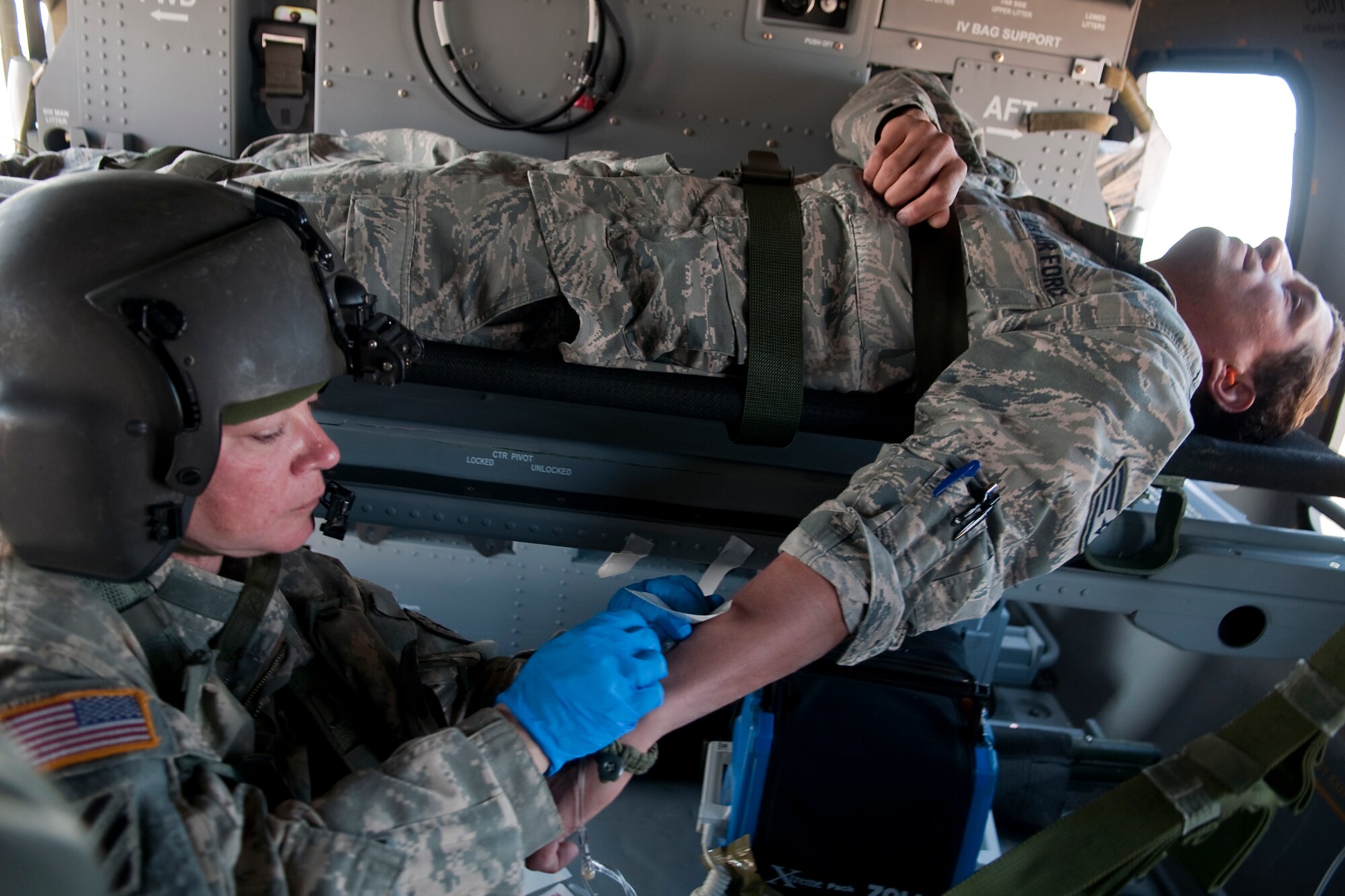 GRISSOM AIR RESERVE BASE, Ind. -- Staff Sgt. Dana Owen, 2-238th General Support Aviation Battalion, Medical Evacuation Unit flight medic, starts an IV on an Airman volunteer during a simulated aeromedical evacuation mission April 26. The 2-238th MEDEVAC is gearing up for a deployment to Southwest Asia this fall. (U.S. Air Force photo/Tech. Sgt. Mark R. W. Orders-Woempner) 

