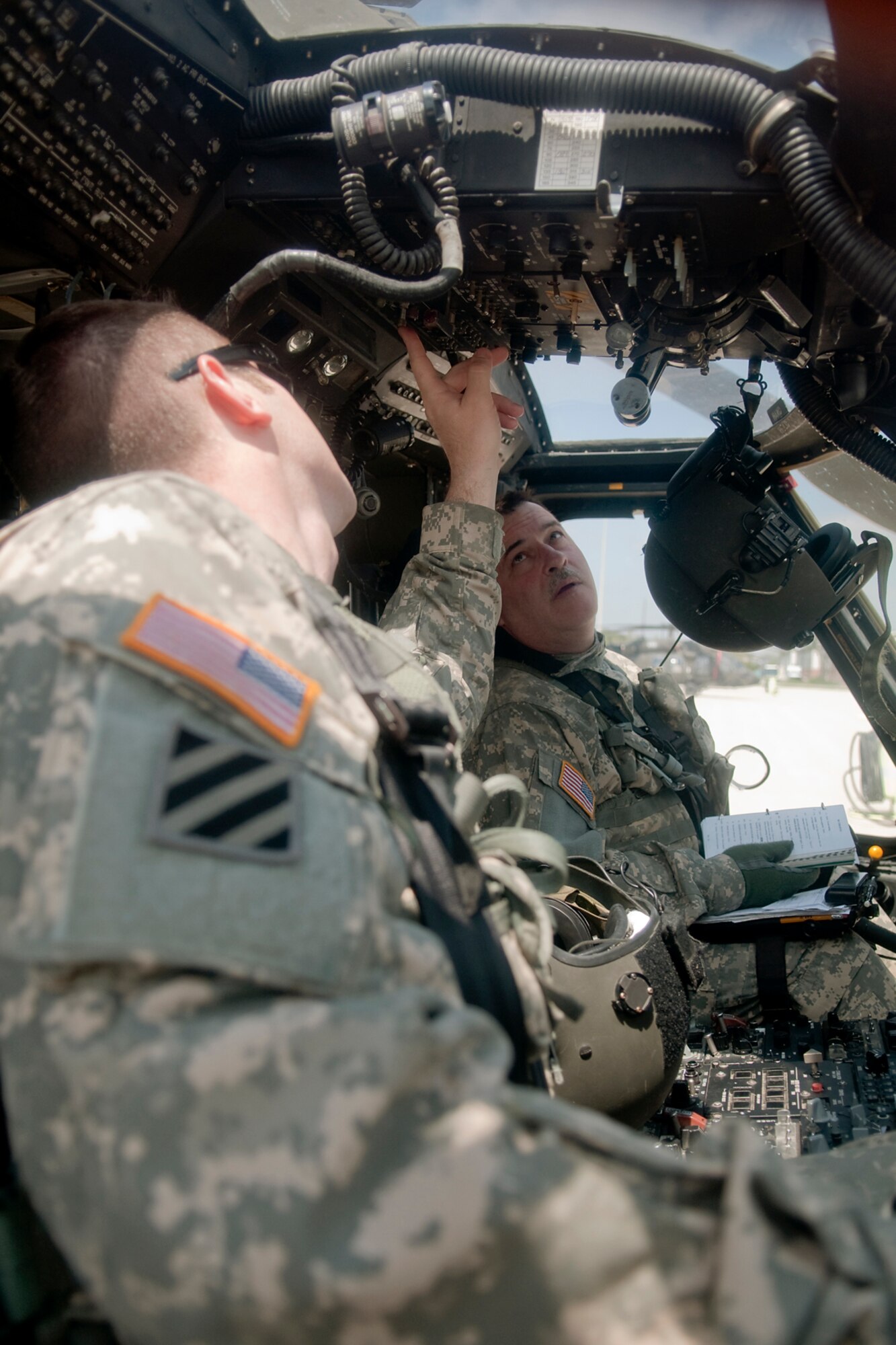 GRISSOM AIR RESERVE BASE, Ind. -- Capt. Aaron Fletcher, left, and Chief Warrant Officer 3 Ron Walker make sure their UH-60 Black Hawk is ready to fly at a moment's notice after prepositioning the aircraft during a training exercise April 26. Both pilots are members of the 2-238th General Support Aviation Battalion, Medical Evacuation Unit, which descended upon Grissom April 17 for two weeks of intense pre-deployment training. (U.S. Air Force photo/Tech. Sgt. Mark R. W. Orders-Woempner) 
