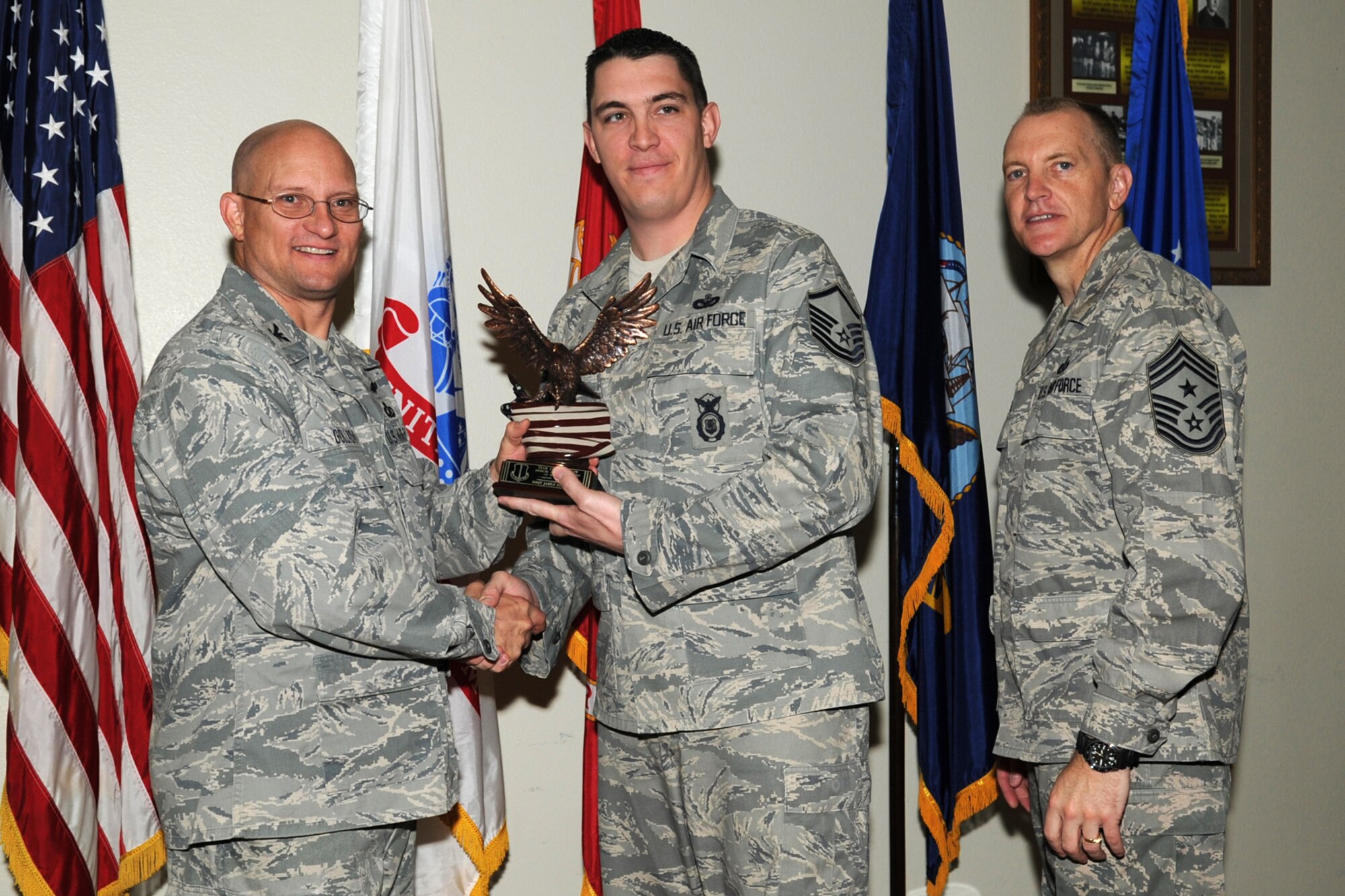 GOODFELLOW AIR FORCE BASE, Texas -- Col. William Golladay, 17th Training Wing Vice Commander, and Chief Master Sgt. Scott Lumpkin, 17th TRW Command Chief, present the Team Goodfellow Senior Servicemember of the Quarter award to Master Sgt. James Eselgroth, 17th Security Forces Squadron, during the wing quarterly awards ceremony April 24. (U.S. Air Force photo/Staff Sgt. Laura R. McFarlane)