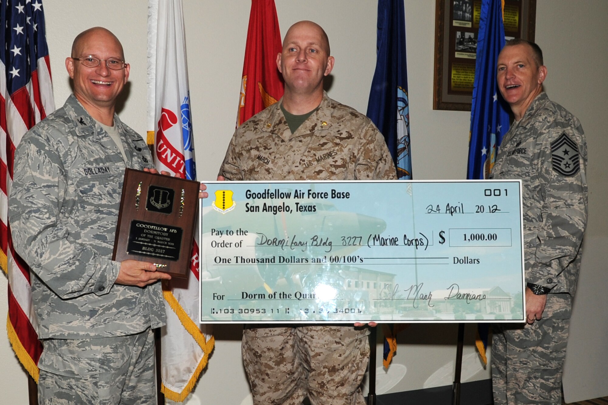 GOODFELLOW AIR FORCE BASE, Texas -- Col. William Golladay, 17th Training Wing Vice Commander, and Chief Master Sgt. Scott Lumpkin, 17th TRW Command Chief, present Marine Maj. Douglas March with the Team Goodfellow, Goodfellow Air Force Base Dormitory of the Quarter for Building 3227 during the wing quarterly awards ceremony April 24. (U.S. Air Force photo/Staff Sgt. Laura R. McFarlane)
