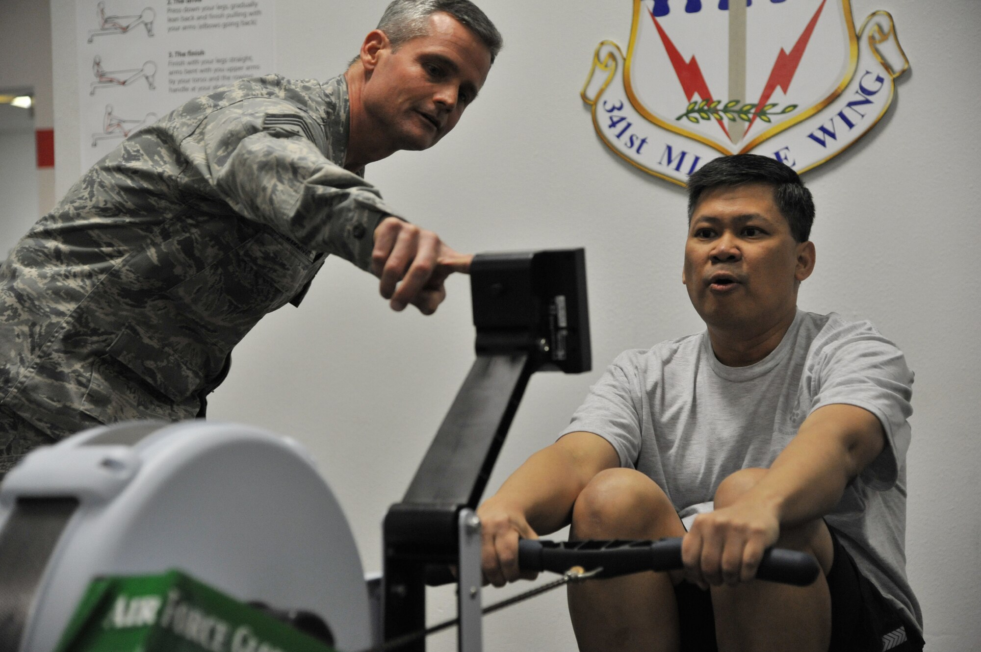 Chief Master Sgt. Chuck Anderson, 341st Missile Wing command chief, assists Col. H.B. Brual, 341st MW commander, during a rowing session scheduled for the base's colonels April 20. The group rowed a total of 9,303 meters between them. As of April 19, Malmstrom was in second place overall in the Air Force Global Strike Command-wide rowing challenge, trailing Minot Air Force Base by only a few meters. Rowing with Brual Friday were Col. Rob Stanley, 341st MW vice commander; Col. Robert Mendenhall, 341st Security Forces Group commander; Col. Ed Rimback, 341st Operations Group commander; Col. Angela Stout, 341st Mission Support Group commander; Col. Bruce Roehm, 341st Medical Group commander; Col. Dave Bliesner, 341st Maintenance Group commander; and Lt. Col. Tom Rudy, 341st Operations Group deputy commander. (Rudy is also a colonel select.) The rowing competition continues through May 5 and the base that achieves the highest cumulative amount of meters rowed will win $50,000 in quality of life money. (U.S. Air Force photo/John Turner)