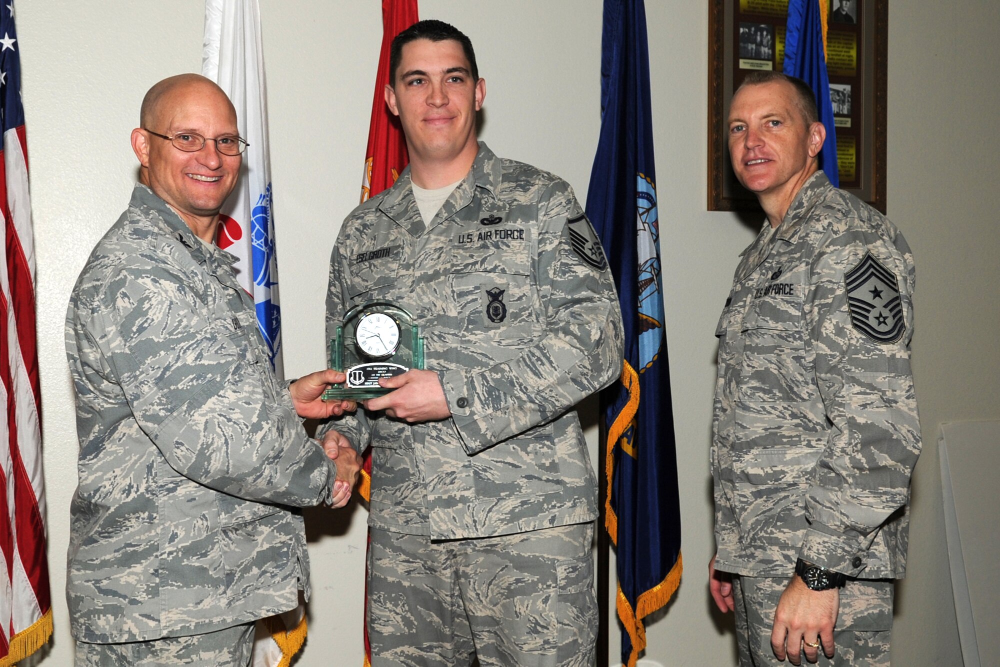 GOODFELLOW AIR FORCE BASE, Texas -- Col. William Golladay, 17th Training Wing Vice Commander, and Chief Master Sgt. Scott Lumpkin, 17th TRW Command Chief, present the 17th Training Wing Senior NCO of the Quarter to Master Sgt. James Eselgroth, 17th Security Forces Squadron, during the wing quarterly awards ceremony April 24. (U.S. Air Force photo/Staff Sgt. Laura R. McFarlane)