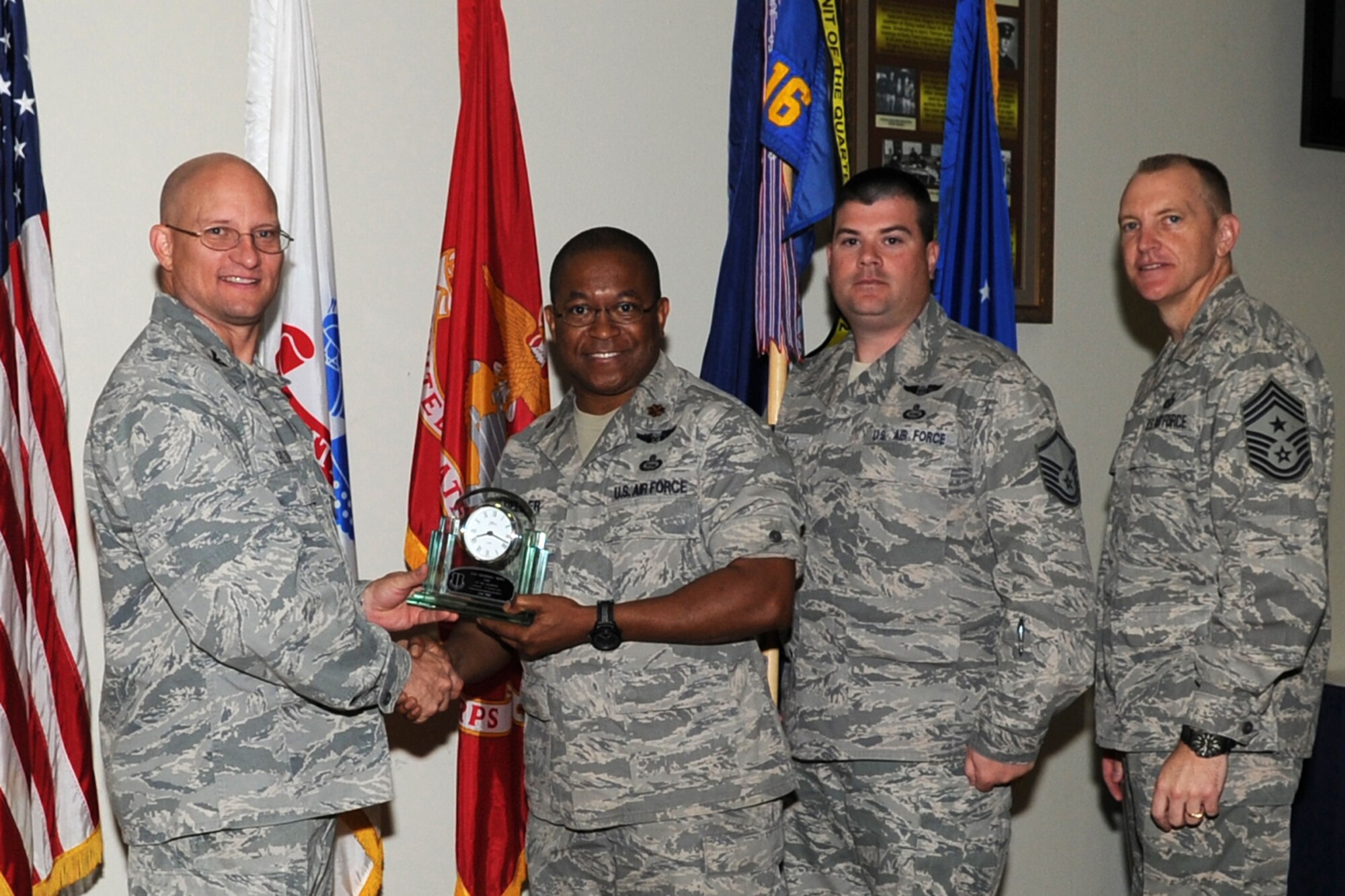 GOODFELLOW AIR FORCE BASE, Texas -- Col. William Golladay, 17th Training Wing Vice Commander, and Chief Master Sgt. Scott Lumpkin, 17th TRW Command Chief, present the 17th Training Wing Unit of the Quarter to Maj. Clarence Fielder and Master Sgt. Dennis Hall, 316th Training Squadron, during the wing quarterly awards ceremony April 24. (U.S. Air Force photo/Staff Sgt. Laura R. McFarlane)
