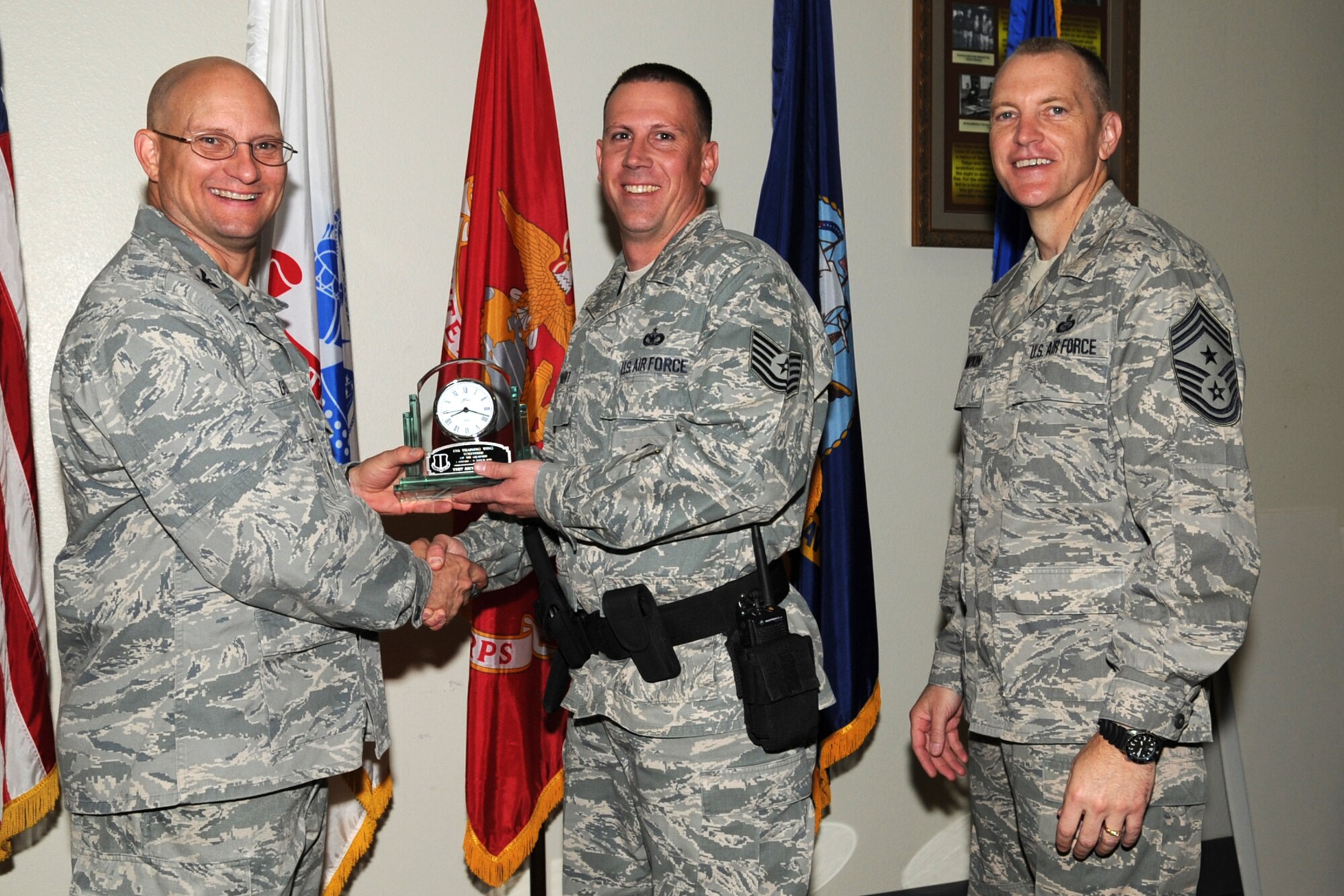 GOODFELLOW AIR FORCE BASE, Texas -- Col. William Golladay, 17th Training Wing Vice Commander, and Chief Master Sgt. Scott Lumpkin, 17th TRW Command Chief, present the 17th Training Wing Volunteer of the Quarter to Tech. Sgt. Richard Bart, 17th Security Forces Squadron, during the wing quarterly awards ceremony April 24. (U.S. Air Force photo/Staff Sgt. Laura R. McFarlane)