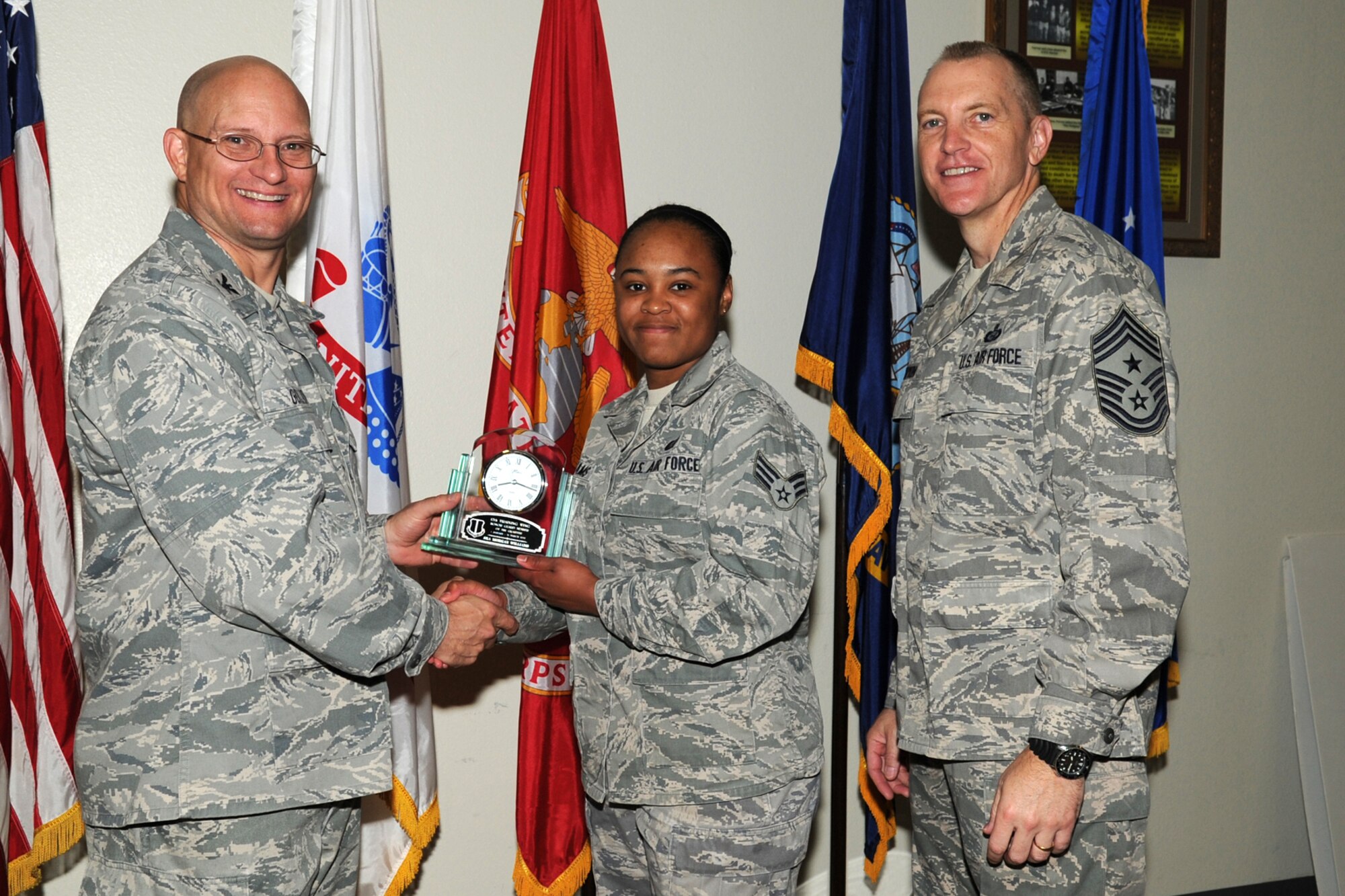 GOODFELLOW AIR FORCE BASE, Texas -- Col. William Golladay, 17th Training Wing Vice Commander, and Chief Master Sgt. Scott Lumpkin, 17th TRW Command Chief, present the 17th Training Wing Honor Guard of the Quarter to Senior Airman Morgan Williams, 17th Force Support Squadron, during the wing quarterly awards ceremony April 24. (U.S. Air Force photo/Staff Sgt. Laura R. McFarlane)