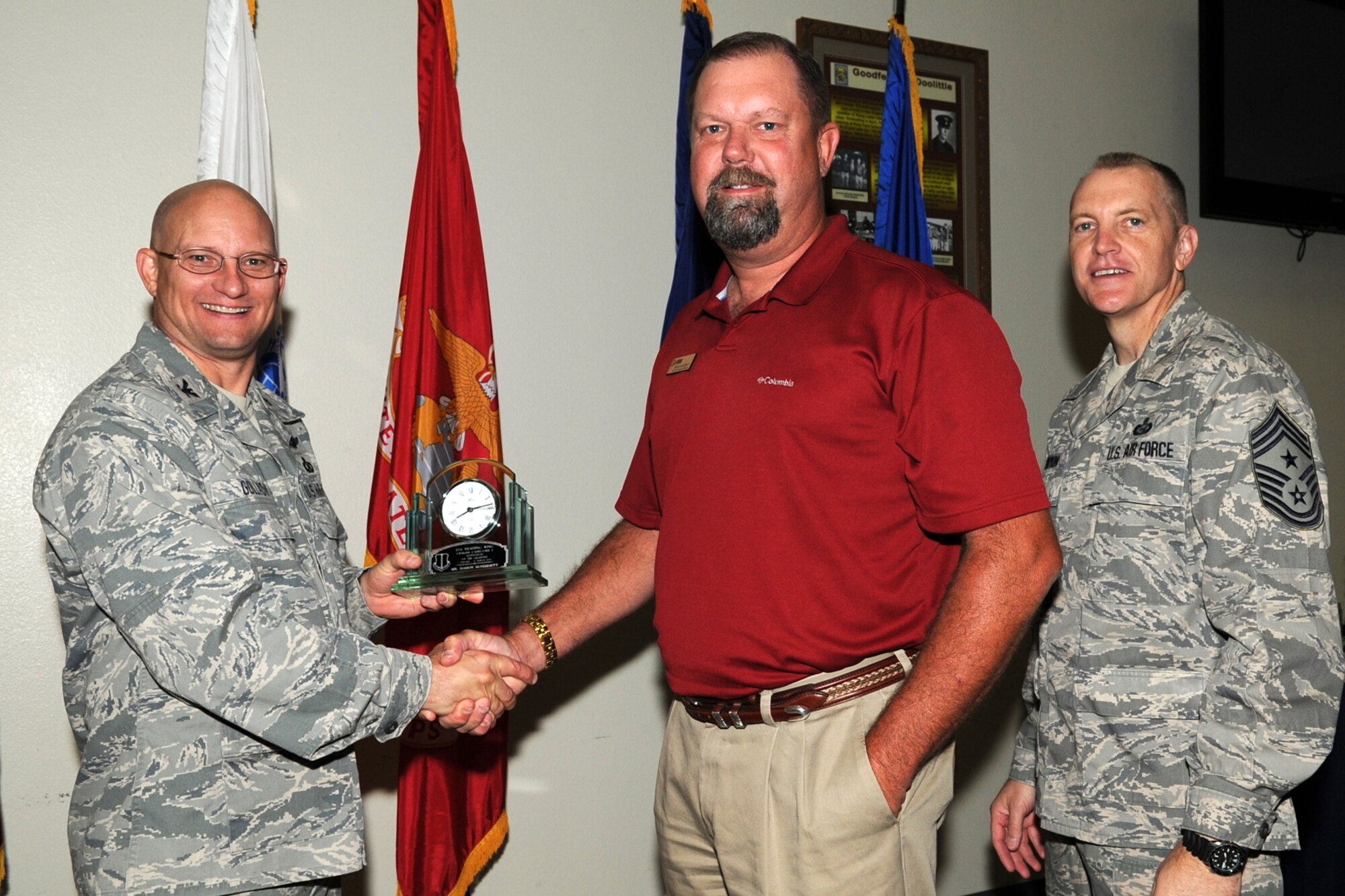 GOODFELLOW AIR FORCE BASE, Texas -- Col. William Golladay, 17th Training Wing Vice Commander, and Chief Master Sgt. Scott Lumpkin, 17th TRW Command Chief, present the 17th Training Wing Civilian Supervisor of the Quarter Category I to Damon McDurmitt, 17th Force Support Squadron, during the wing quarterly awards ceremony April 24. (U.S. Air Force photo/Staff Sgt. Laura R. McFarlane)