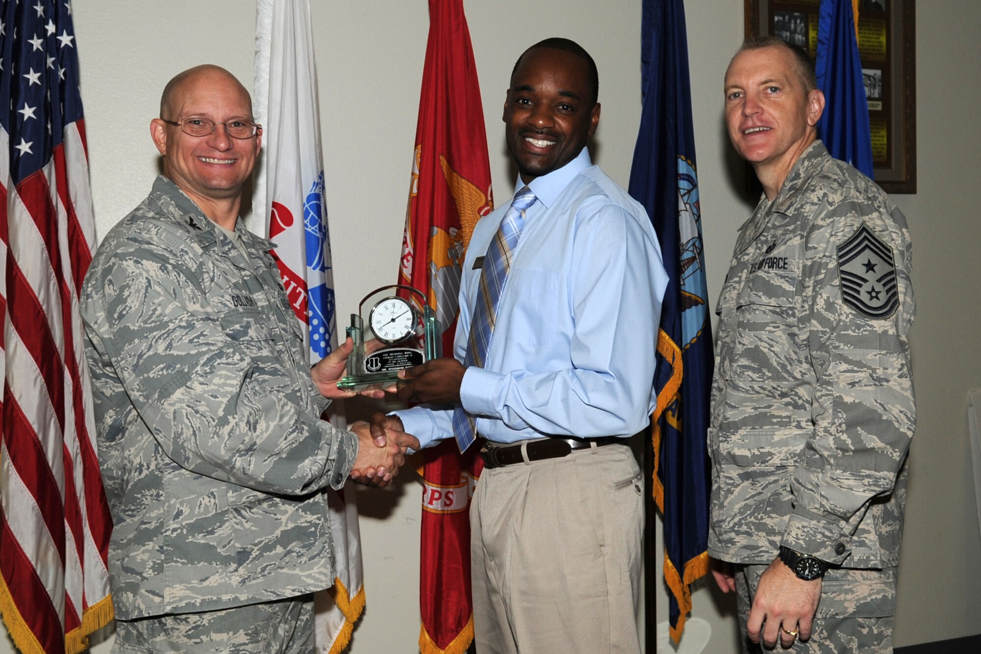 GOODFELLOW AIR FORCE BASE, Texas -- Col. William Golladay, 17th Training Wing Vice Commander, and Chief Master Sgt. Scott Lumpkin, 17th TRW Command Chief, present the 17th Training Wing Civilian of the Quarter Category II to Woodrow Rorie, 17th Force Support Squadron, during the wing quarterly awards ceremony April 24. (U.S. Air Force photo/Staff Sgt. Laura R. McFarlane)