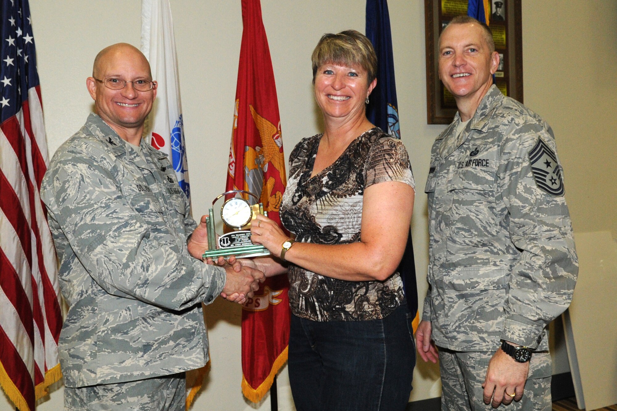 GOODFELLOW AIR FORCE BASE, Texas -- Col. William Golladay, 17th Training Wing Vice Commander, and Chief Master Sgt. Scott Lumpkin, 17th TRW Command Chief, present the 17th Training Wing Civilian of the Quarter Category I to Cindy Middleton, 17th TRW Staff, during the wing quarterly awards ceremony April 24. (U.S. Air Force photo/Staff Sgt. Laura R. McFarlane)