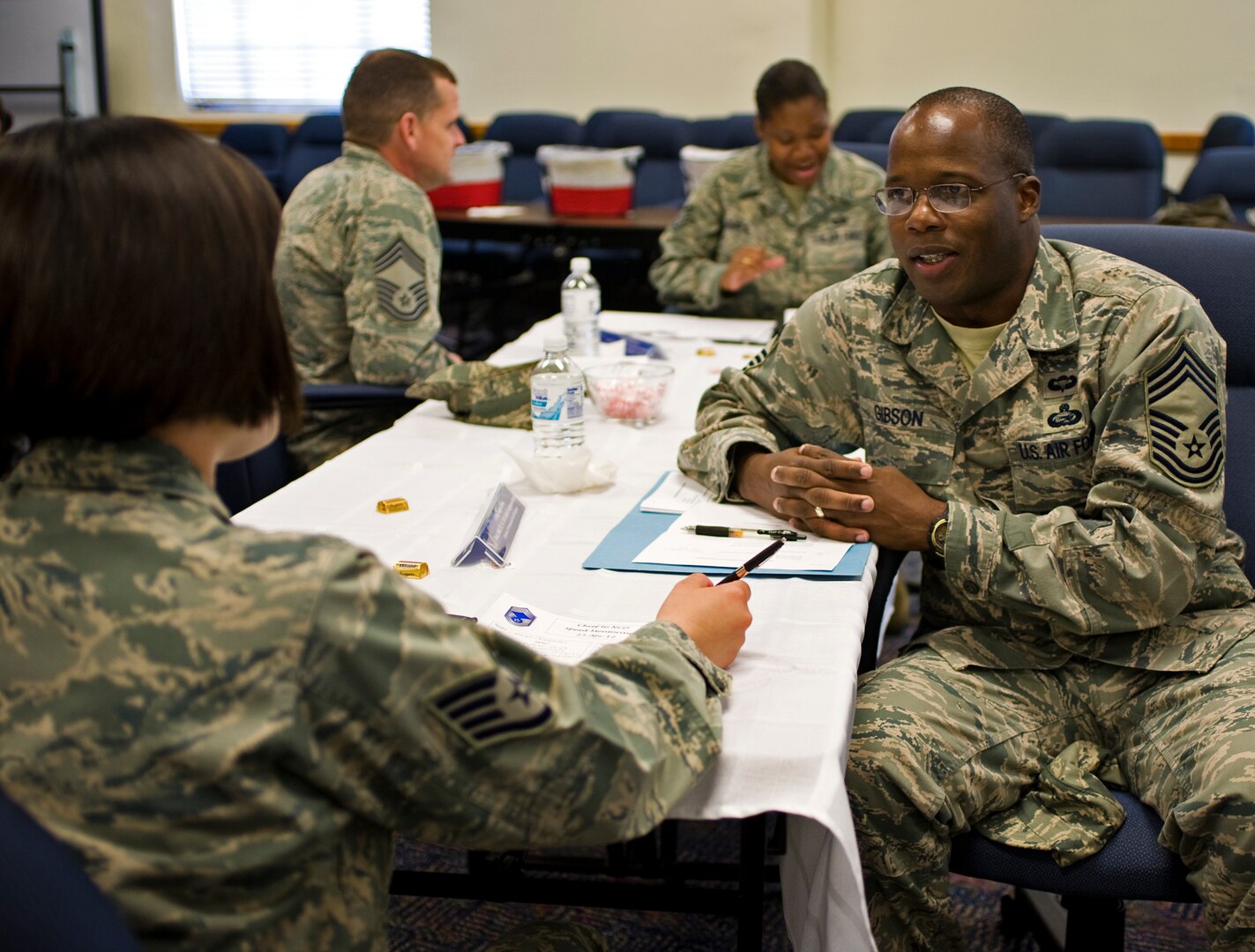 Staff Sgt. Erica Fielding, Air Force Personnel Center, takes notes from Chief Master Sgt. Vaughn Gibson, AFPC Enlisted Logistics Support Assignments chief,  about the direction the Air Force is going in the next ten years. The Rising 5/6 hosted a speed mentoring seminar April 25 at Joint Base San Antonio-Randolph. (U.S. Air Force photo by Benjamin Faske)