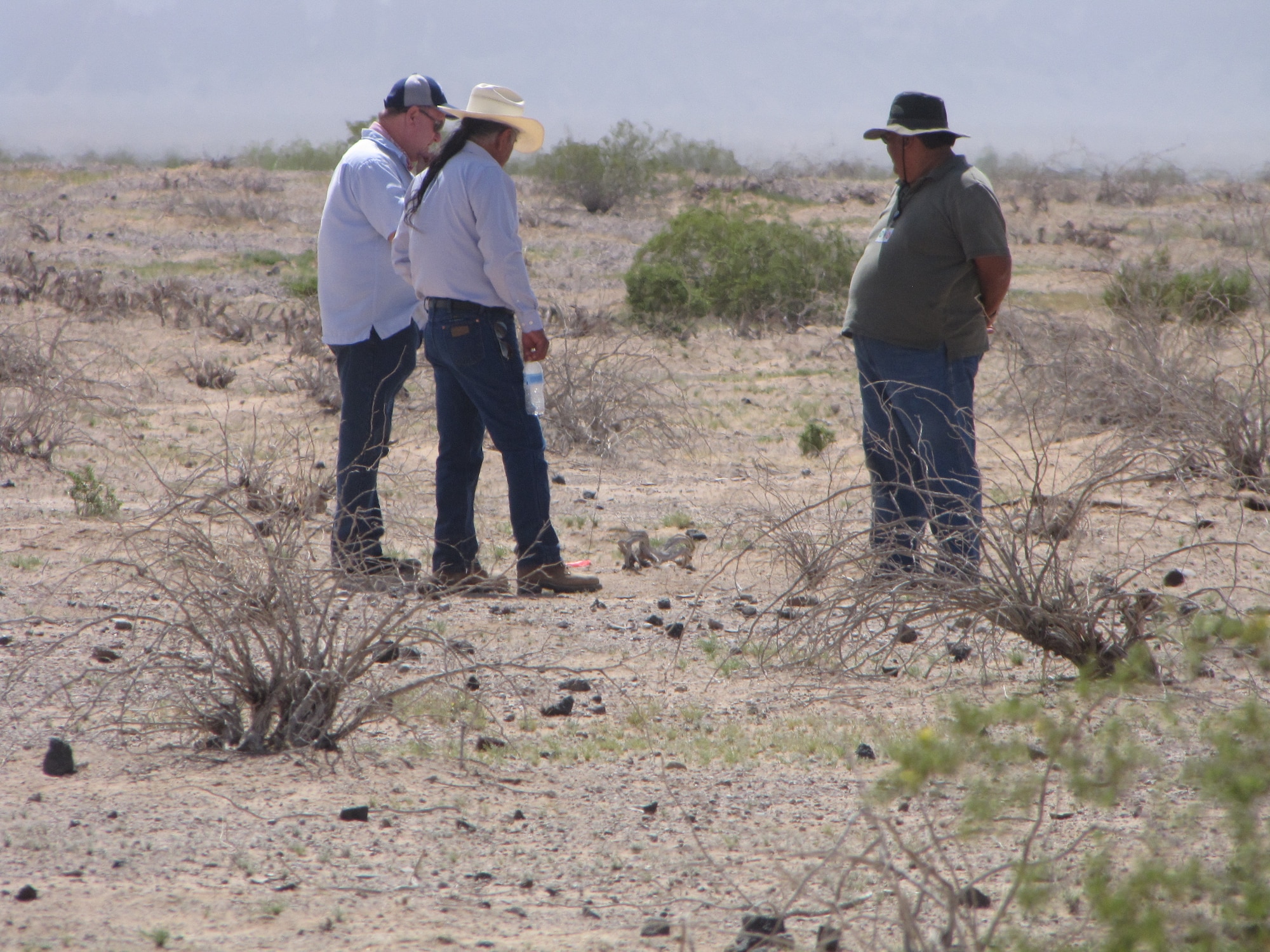 Dr. David Doyel, 56th Range Management Office archaeologist, discusses protocol with Barnaby Lewis of the Gila River Indian Community while Larry Benallie of the same tribe looks on. Protocols are established to identify and mitigate impacts to cultural resources discovered at Lago Saco and other sites on the Barry M. Goldwater Range-East. 56th RMO conducts ongoing consultations with Native American tribes who claim an affiliation with the BMGR.  (U.S. Air Force photy by Adrianne Rankin)