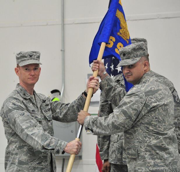U.S. Air Force Col. William West, 27th Special Operations Group commander, passes the guidon to Lt. Col James Chappelear, 56th Special Operations Intelligence Squadron commander during the 56 IS inactivation ceremony at Cannon Air Force Base, N.M., April 27, 2012.The passing of the guidon signifies the change in command. (U.S Air Force photo Airman 1st Class Xavier Lockley)