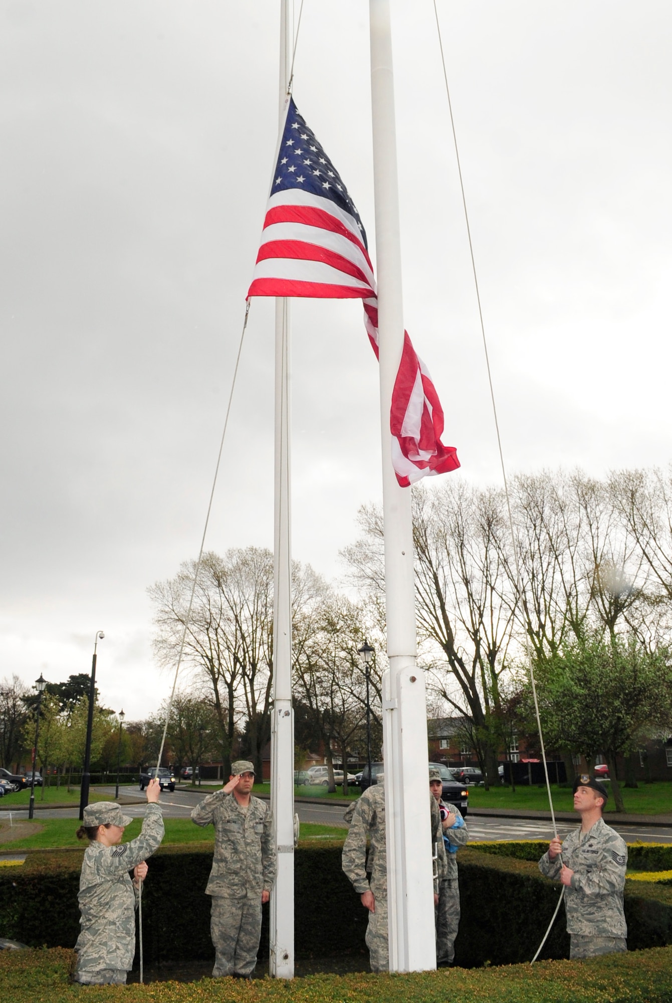 RAF MILDENHALL, England – Airmen from the 352nd Special Operations Group, lower the American flag during a retreat ceremony here April 27, 2012. Retreat signals the end of the duty day, while also paying respect to the flag. (U.S. Air Force photo/Senior Airman Ethan Morgan)