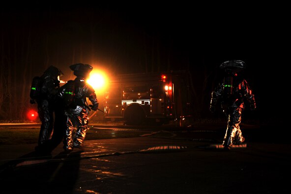 U.S. Air Force firefighters from the 35th Civil Engineer Squadron drag simulated victims out of a burning building during an operational readiness exercise at Misawa Air Base, Japan, April 30, 2012. OREs help Airmen develop skills needed in a deployed environment. (U.S. Air Force photo by Airman 1st Class Kia Atkins/Released)