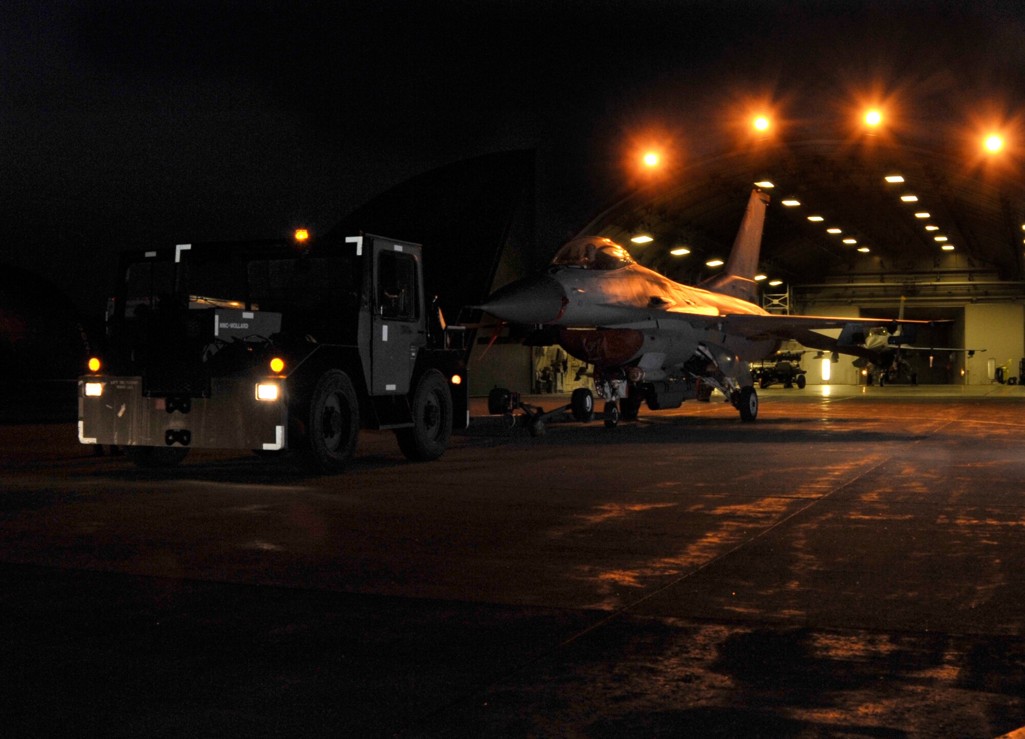U.S. Air Force Airmen from the 35th Aircraft Maintenance Squadron tow an F-16 Fighting Falcon during an operational readiness exercise at Misawa Air Base, Japan, April 28, 2012. The purpose of the exercise is to demonstrate and evaluate the wing's ability to quickly generate and employ war-ready aircraft. (U.S. Air Force photo by Staff Sgt. Nathan Lipscomb/Released)