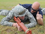 Andy Anderson tells U.S. Air Force Airman 1st Class Randall Gilley how many meters to lead his team while practicing setting perimeters in preparation for an operational readiness exercise on Seymour Johnson Air Force Base, N.C., April 26, 2012. Perimeters must be set in order to defend a valuable asset against hostile forces. Anderson, 4th Security Forces Squadron lead instructor, hails from Summerville, S.C. Gilley, 4th Civil Engineer Squadron water and fuels systems maintenance journeyman, hails from Texas. (U.S. Air Force photo/Airman 1st Class Aubrey Robinson/Released)