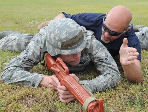 Andy Anderson tells U.S. Air Force Airman 1st Class Randall Gilley how many meters to lead his team while practicing setting perimeters in preparation for an operational readiness exercise on Seymour Johnson Air Force Base, N.C., April 26, 2012. Perimeters must be set in order to defend a valuable asset against hostile forces. Anderson, 4th Security Forces Squadron lead instructor, hails from Summerville, S.C. Gilley, 4th Civil Engineer Squadron water and fuels systems maintenance journeyman, hails from Texas. (U.S. Air Force photo/Airman 1st Class Aubrey Robinson/Released)