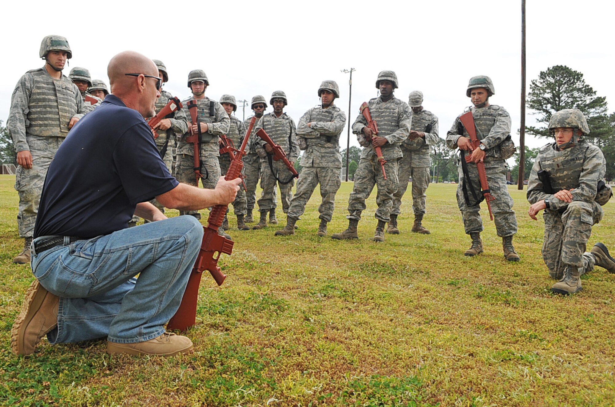 4th Civil Engineer Squadron Airmen watch as Andy Anderson displays different weapon handling techniques in preparation for an upcoming operational readiness exercise on Seymour Johnson Air Force Base, N.C., April 26, 2012. The ORE will test the base’s ability to respond to an array of incidents while force protection conditions fluctuate. Anderson, 4th Security Forces Squadron lead instructor, hails from Summerville, S.C. (U.S. Air Force photo/Airman 1st Class Aubrey Robinson/Released)