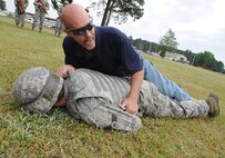 U.S. Air Force Senior Airman Michael Worley is tackled while simulating combat-related incidents in preparation for an operational readiness exercise on Seymour Johnson Air Force Base, N.C., April 26, 2012. The purpose of the simulation is to make Airmen aware of the dangers of a grenade attack brought on by someone lying with their arms underneath their body. Worley is a 4th Civil Engineer Squadron water and fuels systems maintenance journeyman. (U.S. Air Force photo/Airman 1st Class Aubrey Robinson/Released)