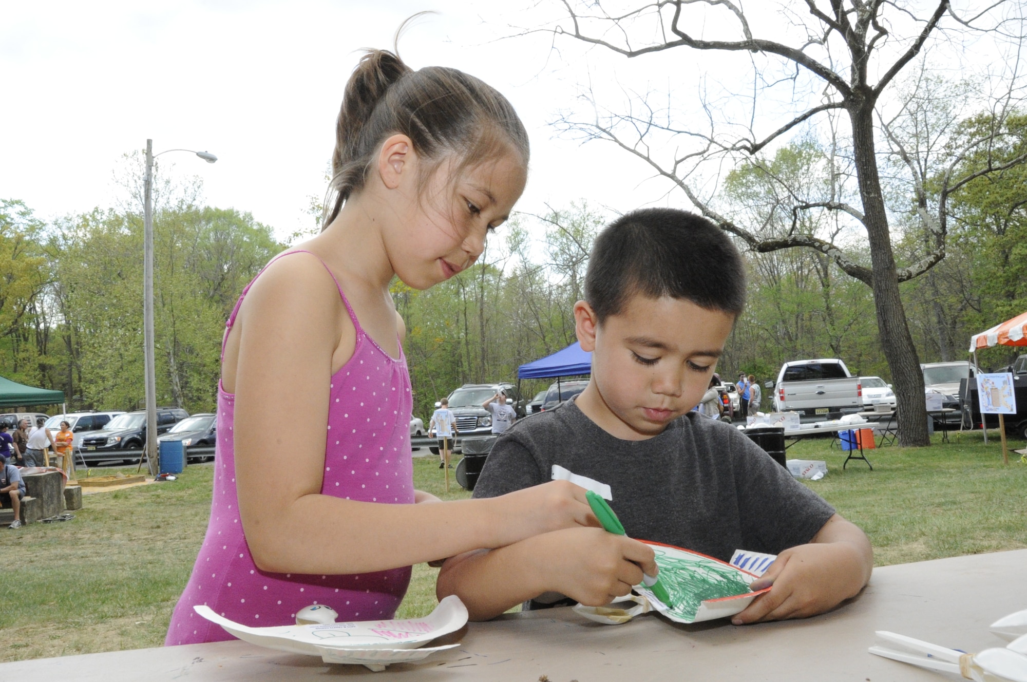 Christina, 11, and Ryan, 6, color in the tail of Ryan’s paper dove he built during the Joint Base McGuire-Dix-Lakehurst Earth Day event April 21 at the Laurel Pond Recreation Area. Christina and Ryan are children of Mary and Master Sgt. Stephen Cochling, U.S. Air Force Expeditionary Center instructor. They later tested their doves to see how far they would fly. This arts and crafts activity was one of the ways community members learned about the importance of Earth Day. (U.S. Air Force photo by Senior Airman Bryan Swink/Released)