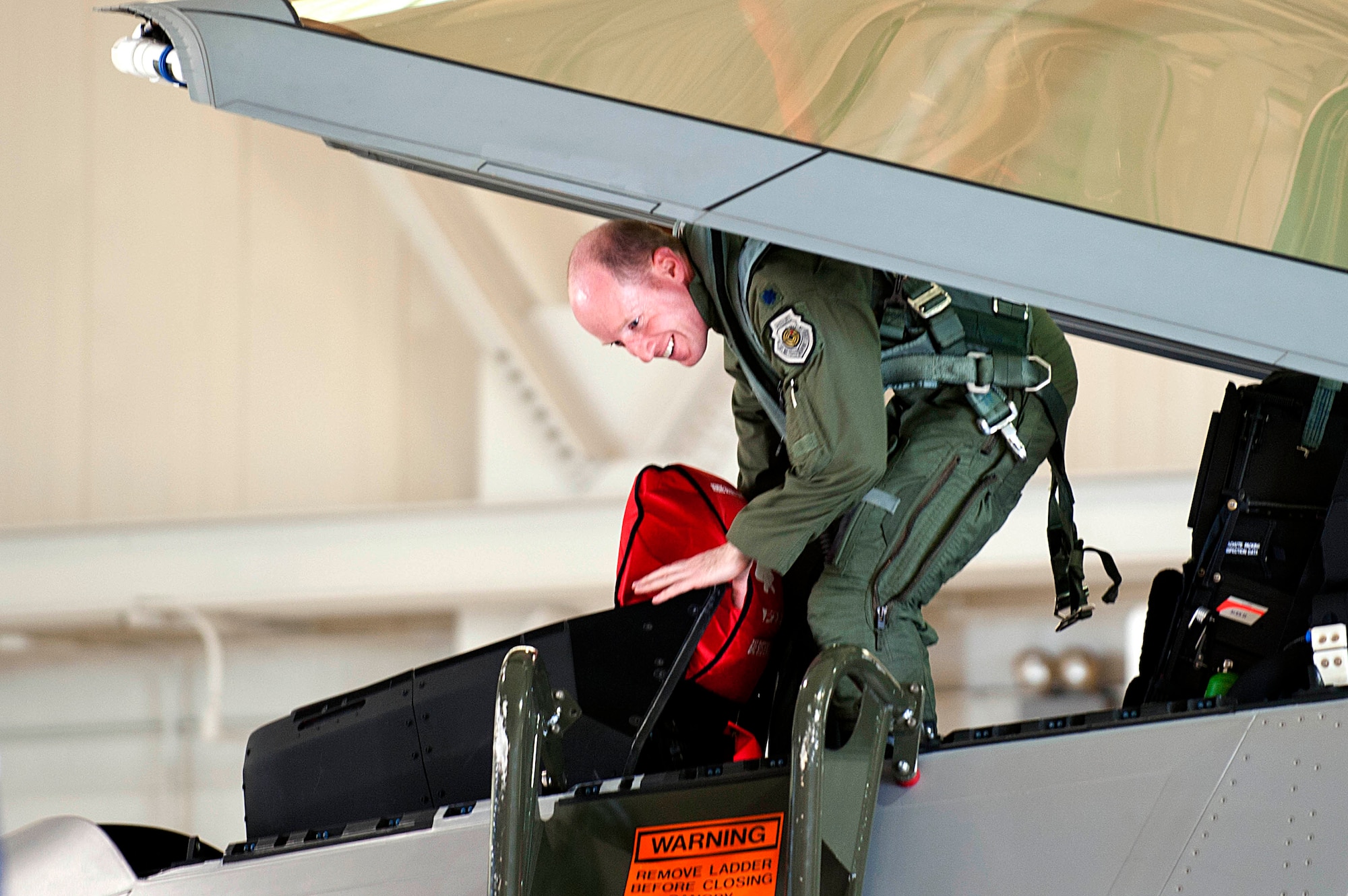 U.S. Air Force Lt. Col. Jason Hinds, 94th Fighter Squadron commander, exits the final F-22 Raptor to arrive at Langley Air Force Base, Va., April 27, 2012.   The F-22 Raptor possesses a sophisticated sensor suite allowing the pilot to track, identify, shoot and kill air-to-air threats before being detected.  (U.S. Air Force photo by Airman 1st Class Kayla Newman/Released)