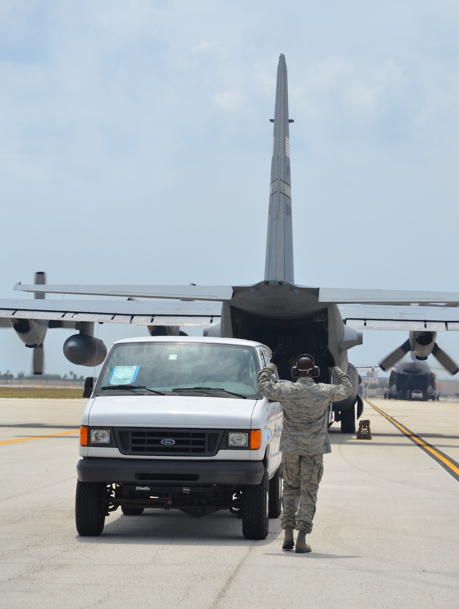 Senior Airman Andre Riobe, an aerial porter with the 42nd Aerial Port Squadron at Westover Air Reserve Base, Mass., directs a van onto a C-130 at Patrick Air Force Base, Fla., as part of Patriot Sands, an airlift exercise at MacDill Air Force Base, Fla., and Patrick AFB, Fla., April 26-29, 2012. Reservists with the 512th Airlift Control Flight, Dover Air Force Base, Del., 452nd ALCF, March Air Reserve Base, Calif., and 439th ALCF, Westover ARB, trained with FBI Rapid Deployment Teams during the exercise. (U.S. Air Force photo by Capt. Marnee A.C. Losurdo)