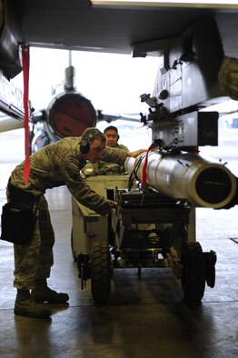 U.S. Air Force Staff Sgt. Derek Pascoe, 35th Aircraft Maintenance Squadron load crew team chief, unloads an AGM-88 high-speed anti-radiation missile from an F-16 Fighting Falcon Aircraft in preparation for phase 2 of an operational readiness exercise at Misawa Air Base, Japan, April 28, 2012. OREs test the combat readiness of the wing and its ability to execute assigned missions and tasks. (U.S. Air Force photo by Airman 1st Class Kia Atkins/Released)
