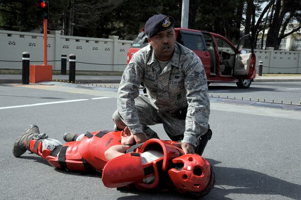 U.S. Air Force Senior Airman Diandre Zachary, 35th Security Forces Squadron patrolman, detains a simulated aggressor during the operational readiness exercise at Misawa Air Base, Japan, April 28, 2012. The exercise allowed Airmen to demonstrate their ability to regain control of a gate runner scenario. (U.S. Air Force photo by Tech. Sgt. Marie Brown/Released)