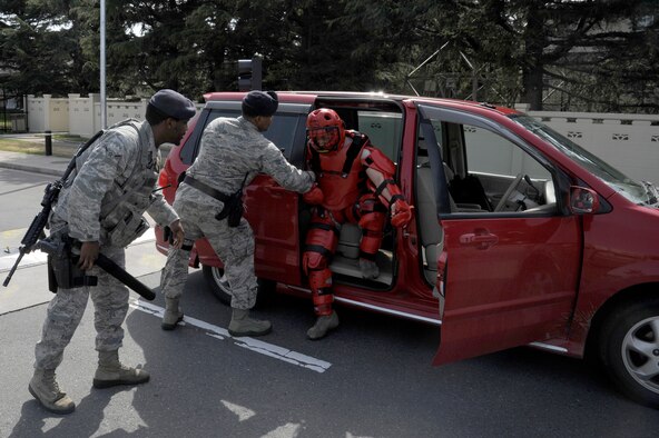 U.S. Air Force Airman Adrian Askew, left, and Senior Airman Diandre Zachary, center, 35th Security Forces Squadron patrolmen, prepare to apprehend a simulated non-compliant suspect during an operational readiness exercise at Misawa Air Base, Japan, April 28, 2012. This exercise gave law enforcement Airmen an opportunity to practice maintaining security around the base. (U.S. Air Force photo by Tech. Sgt. Marie Brown/Released)