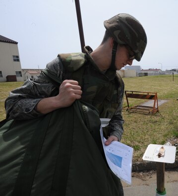 U.S. Air Force Airman 1st Class Michael Palermo, 35th Communication Squadron messaging services technician, checks a prepositioned M8 chemical detection paper during an operational readiness exercise at Misawa Air Base, Japan April 30, 2012. The ORE provides training scenarios that help Airmen hone their skills for a war-time environment. (U.S. Air Force photo by Airman Kenna Jackson, Released)