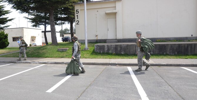 Airmen from the 35th Communication Squadron complete a post-attack reconnaissance sweep during an operational readiness exercise at Misawa Air Base, Japan, April 30, 2012. After simulated attacks, Airmen train by searching immediate areas for unexploded ordinance and rendering aid to injured personnel. (U.S. Air Force photo by Airman Kenna Jackson/Released)