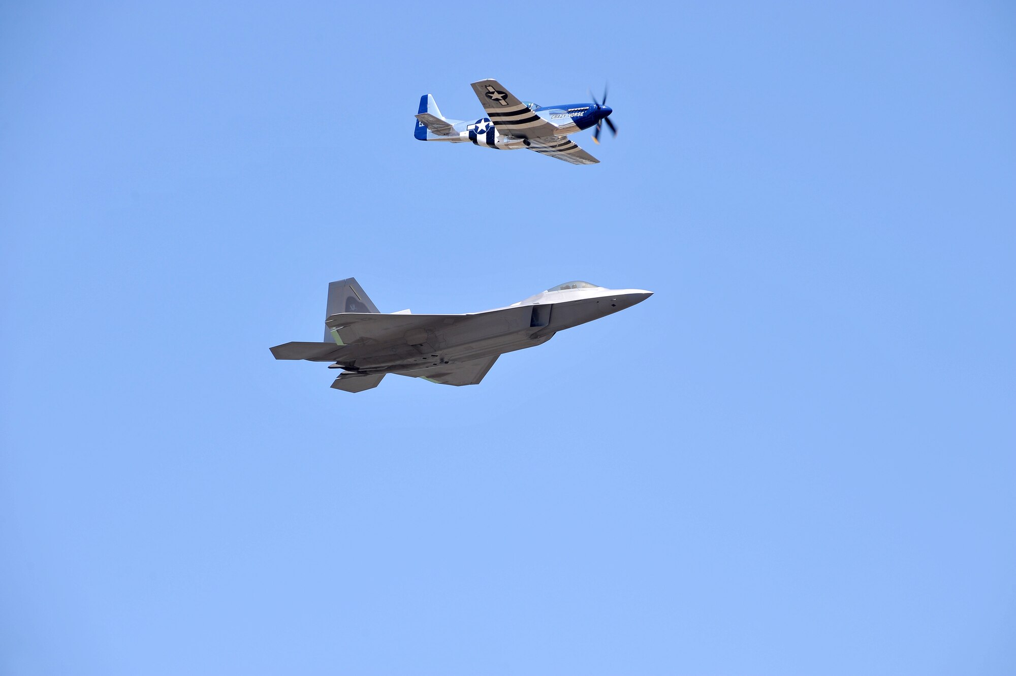 The Heritage Flight mixes the old with the new -- a side-by-side flight by the F-22 Raptor and the P-51 Mustang. The aircraft performed at the 2012 Robins Air Show. (U.S. Air Force photo by Tommie Horton)