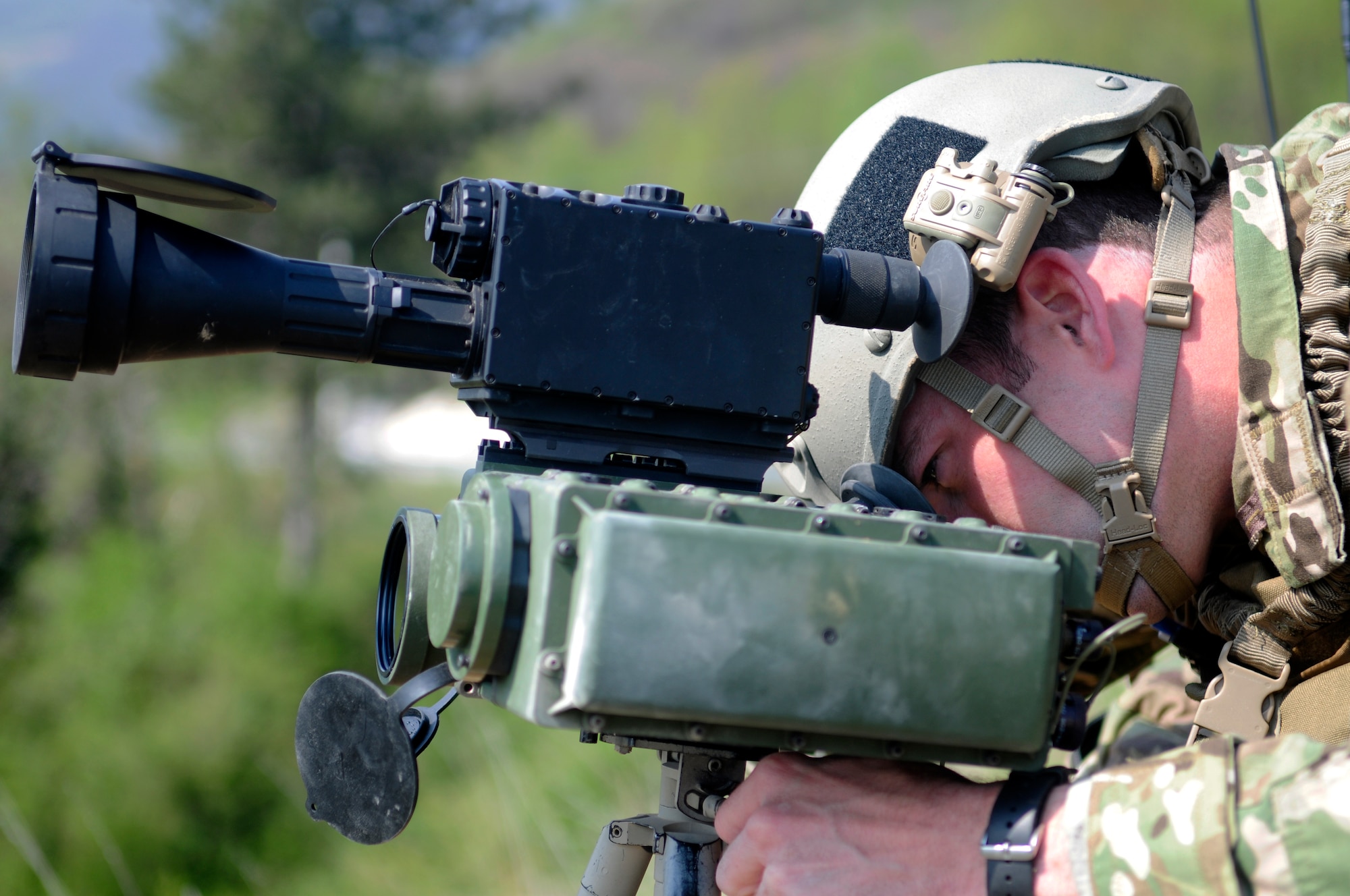 Senior Airman Nathaniel Robie 8th Air Support Operations Squadron tactical air control party member, looks through a scope to acquire a target duringa training mission April 18 in northern Italy. Routine training missions such as this help TACP members maintain proficiency and operate and maintain cutting-edge technology, including communications, computers, digital networks, targeting and surveillance equipment. (U.S. Air Force photo/Airman 1st Class Briana Jones)