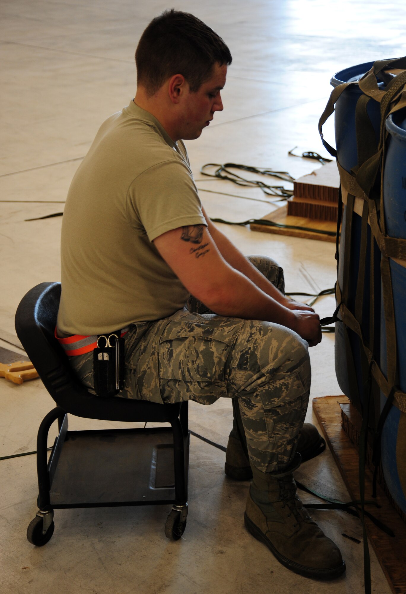 Airman 1st Class Nicholas Jensen, an 86th Logistics Readiness Squadron
rigging specialist puts the finishing touches on a container delivery system
before an airdrop at RAF Fairford, April 24, 2012. CDS drops were scheduled to
occur twice-a-day before so pilots and loadmasters received practice on
carrying out airdrops on unfamiliar drop zones.  (U.S. Air Force photo/Airman 1st Class Trevor Rhynes) 