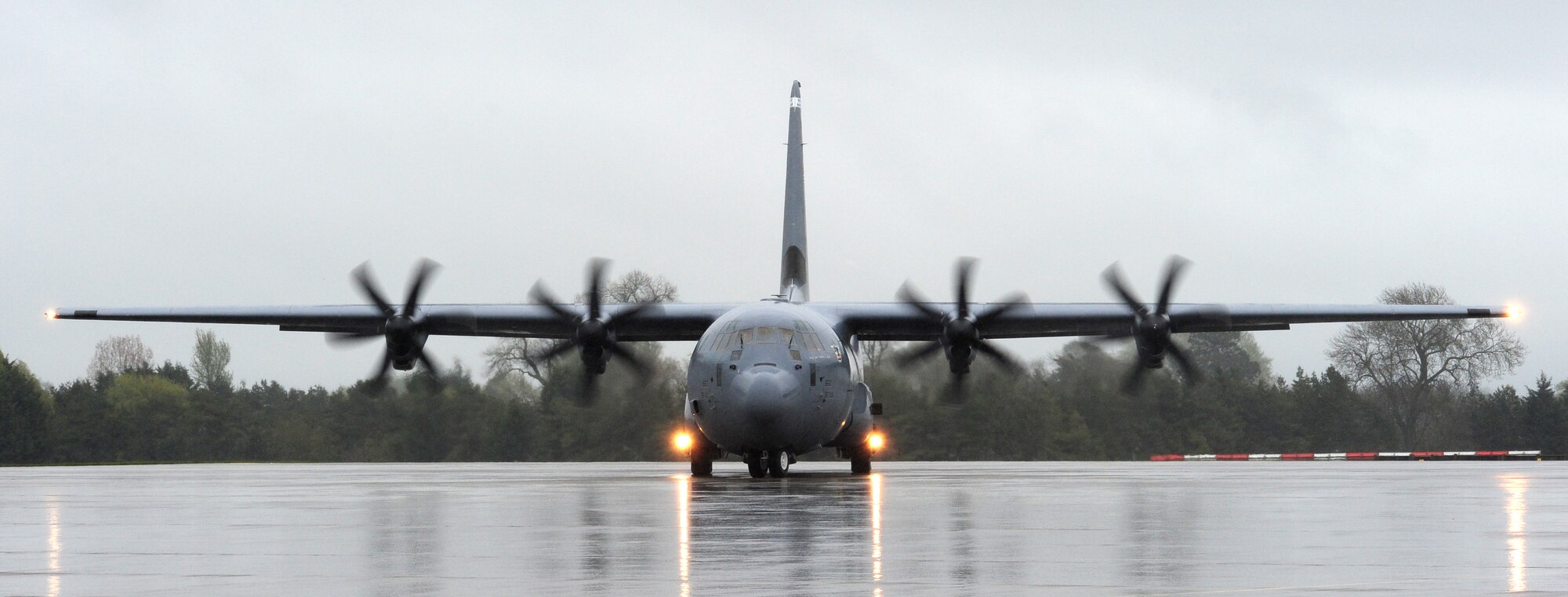 A C-130J Super Hercules taxis on the runway before taking off to perform
low-level flight at RAF Fairford, England, April 25. Pilots of the
37th Airlift Squadron conducted this training to test their ability to fly
through unfamiliar terrain at low levels. (U.S. Air Force photo/Airman 1st
Class Trevor Rhynes)

