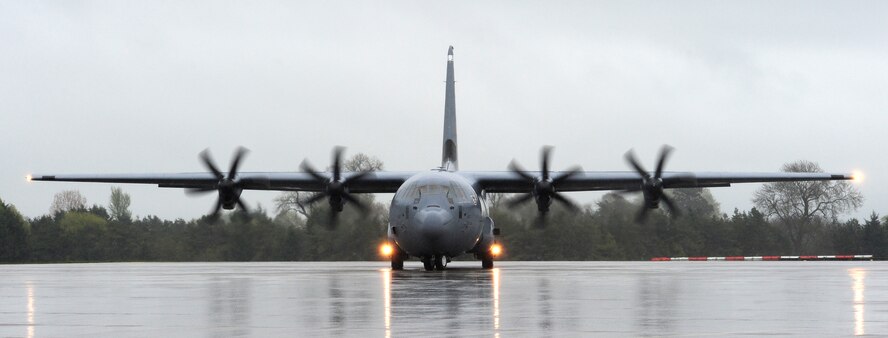 A C-130J Super Hercules taxis on the runway before taking off to perform
low-level flight at RAF Fairford, England, April 25. Pilots of the
37th Airlift Squadron conducted this training to test their ability to fly
through unfamiliar terrain at low levels. (U.S. Air Force photo/Airman 1st
Class Trevor Rhynes)
