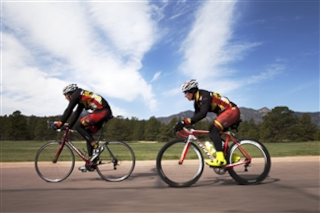 U.S. Marine Corps Sgt. Cogen T. Nelson, right, cycles during practice for the 2012 Warrior Games in Colorado Springs, Colo., on April 28, 2012.  Nelson is a second-time participant in the event and will be competing for the Ultimate Champion title. The Warrior Games is an annual event allowing wounded, ill and injured Service members and veterans to compete in Paralympics sports including archery, cycling, shooting, sitting volleyball, track and field, swimming and wheelchair basketball.  