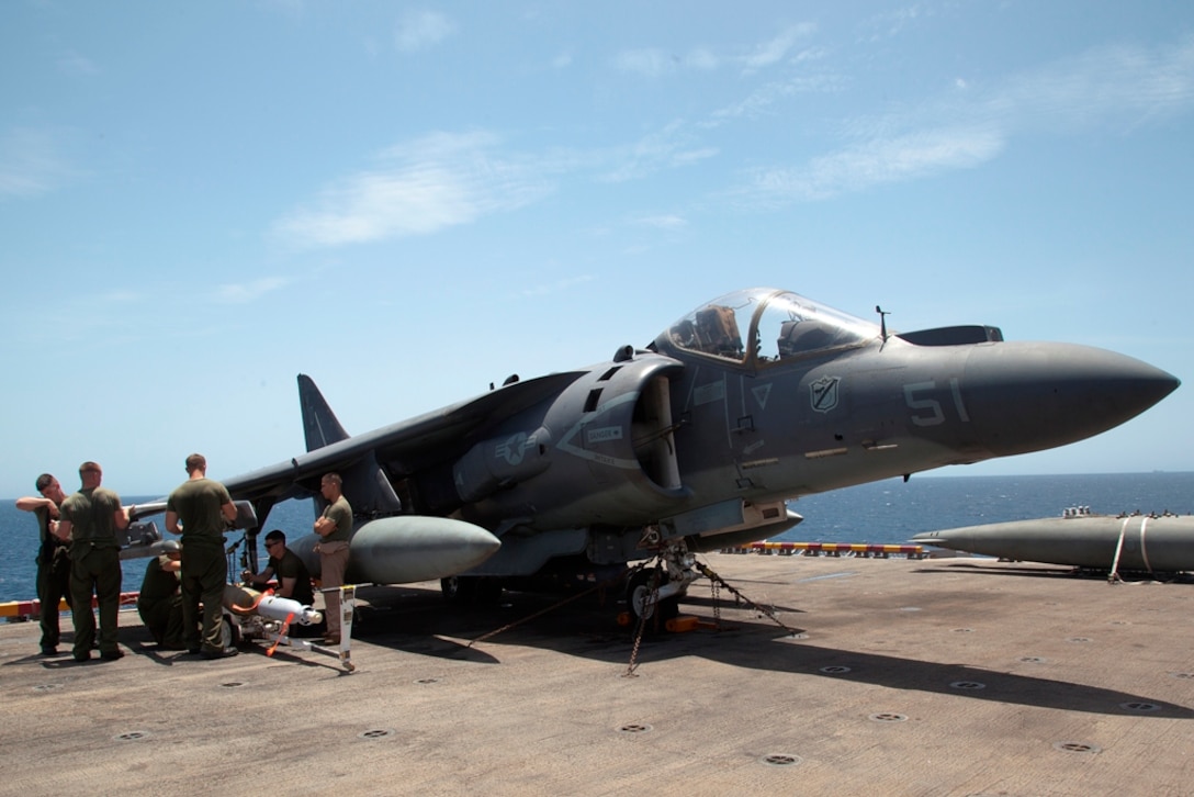 Aviation ordnance technicians with Marine Medium Helicopter Squadron 268 (Reinforced) load 500-pound bombs onto an AV-8B Harrier aircraft aboard USS Makin Island here April 30. The squadron serves as the aviation element for the 11th Marine Expeditionary Unit. The unit is deployed as part of the Makin Island Amphibious Ready Group, currently a U.S. Central Command theater reserve force. The group is providing support for maritime security operations and theater security cooperation efforts in the U.S. Navy's 5th Fleet area of responsibility.