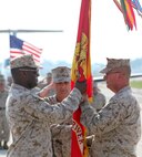 Col. Jeffrey M. Hewlett transfers the Marine Corps Air Station New River colors to Lt. Col. Mitchell E. Cassell at a change of command ceremony aboard the air station, July 27. The passing of the colors symbolizes the transfer of authority to the new commanding officer. Hewlett retired at the ceremony after serving for more than 28 years in the United States Marine Corps.