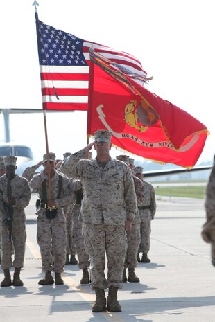 Col. Jeffrey M. Hewlett salutes during the national anthem at a change of command ceremony where he relinquished command of Marine Corps Air Station New River to Lt. Col. Mitchell E. Cassell, July 27. Hewlett retired at the ceremony after having served for more than 25 years in the United States Marine Corps.
