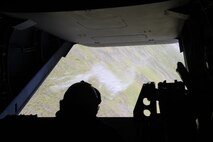 Cpl. William D. Felker, Marine Medium Tiltrotor Squadron 162 MV-22B Osprey crew chief, observes as chaff is jettisoned from the aircraft to practice ground threat reaction in a training flight, July 19. 