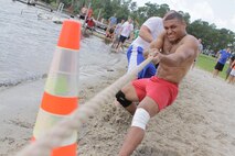 Sections of Headquarters and Headquarters Squadron compete in a double elimination tug-of-war contest on the edge of the water during the second annual regatta for bragging rights and the H&HS regatta trophy at the Marine Corps Air Station New River Marina, July 20. 