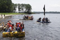 Marines from different sections of Headquarters and Headquarters Squadron take off and paddle their make-shift boats in the second annual regatta boat race at the marina aboard Marine Corps Air Station New River, July 20. The boat race was part of fun competition among the sections of H&HS that included an egg sprint, tug of war contest, pull-up challenge and casualty evacuation race.
