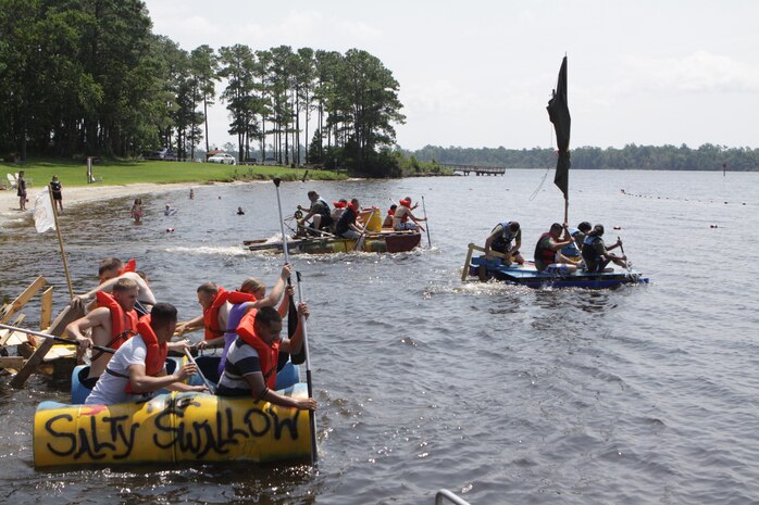 Marines from different sections of Headquarters and Headquarters Squadron take off and paddle their make-shift boats in the second annual regatta boat race at the marina aboard Marine Corps Air Station New River, July 20. The boat race was part of fun competition among the sections of H&HS that included an egg sprint, tug of war contest, pull-up challenge and casualty evacuation race.
