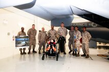 Marines from Marine Corps Air Station New River present Cole Rapini  with gifts from Marine Corps Air Station New River as part of Cole Rapini's visit. The Rapini family has traveled across the country trying to accomplish all of the tasks on 'Cole's Bucket List', a list of activities for Cole and his family to do together. The family received various tokens including a child's flight suit for Cole, a custom paddle laser engraved to commemorate the visit, and a poster with Coles name on it, July 24.

