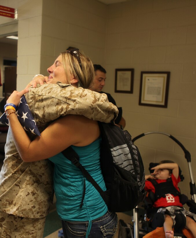 Hanna Rapini, mother of Cole Ripini, hugs Gunnery Sgt. Jermaine Kemp, the coordinator of Rapinis's visit to Marine Corps Air Station New River. The Marines from the air station put together a tour for the family when Kemp was informed of Cole's condition as well as 'Coles Bucket List,' July 24.