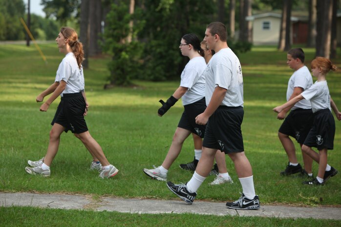 Young Marines from the Young Marine program aboard Marine Corps Air Station New River march en route to their physical fitness training, July 25. The Young Marines are participating in a weeklong encampment in Florida beginning Aug. 4. During their trip, the Young Marines will participate in various activities such as swim qualification, small-arms fire and outdoors survival.
